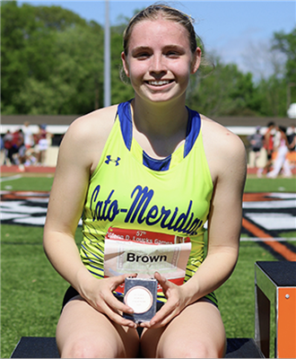 Brown posing with a medal she earned at the games. 