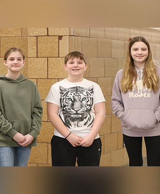  Students pose for a photo in the hallway